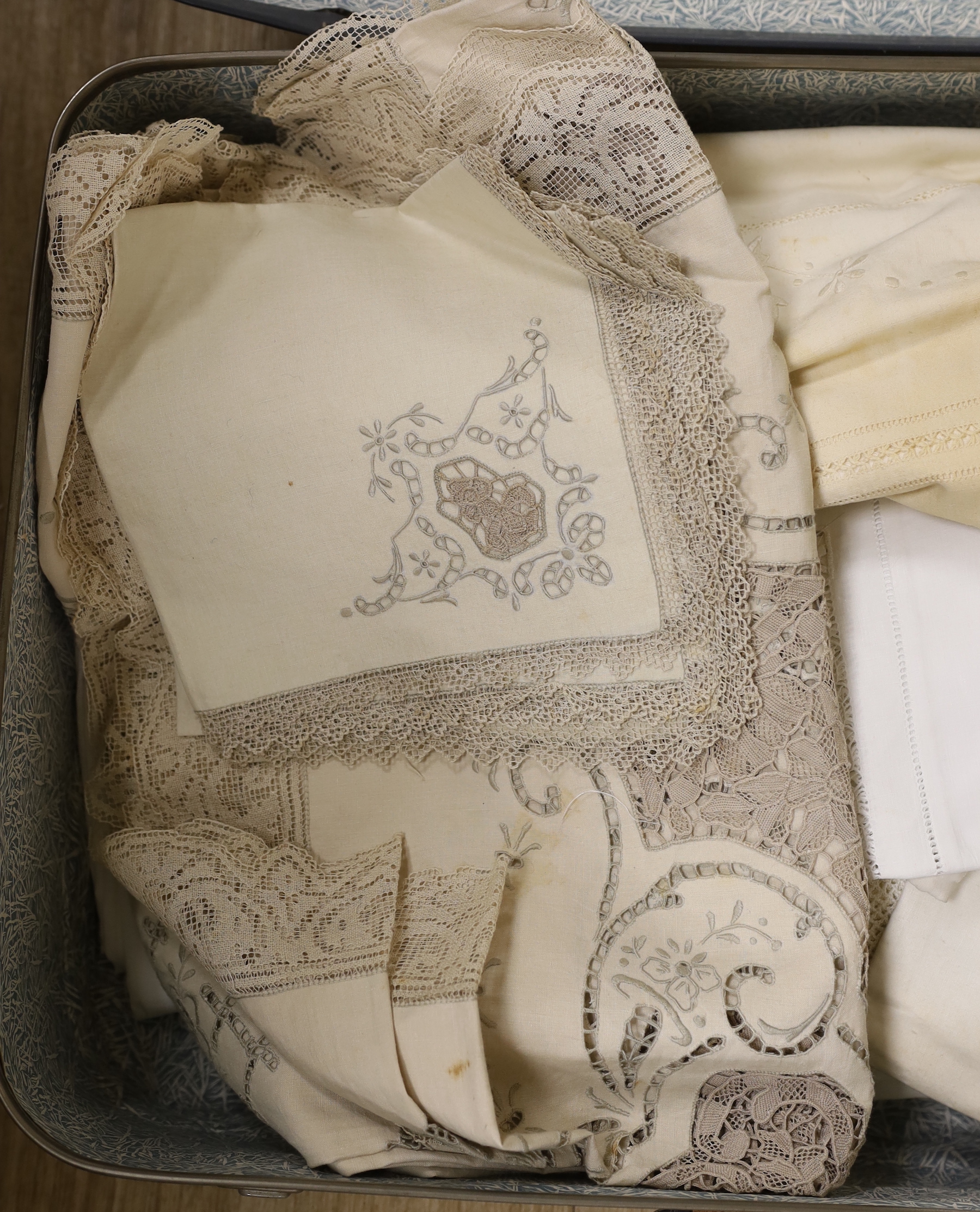 An embroidered linen sheet, a collection of crochet edged table cloths and an embroidered Madeira cloth and matching napkins